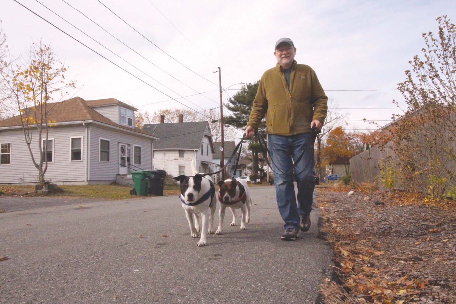 THEY WON’T BE GOING:  Jamie Boblitt and Jack and Freckles do their walk on Bellman Avenue. The dogs won’t be accompanying him when he takes on the Appalachian trail next spring.